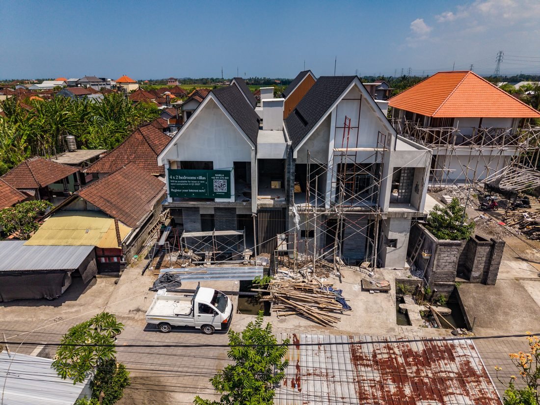 Four Palms front elevation under construction, roofs on and scaffolding in place, 22 September 2026